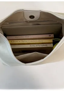 Macro shot of spacious tote bag interior with herringbone lining and magnetic closure