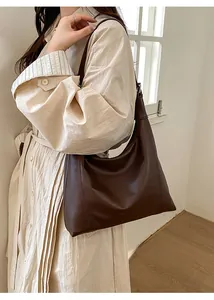 Detail view of the deep brown Hobo tote bag featuring a soft texture and wide shoulder strap