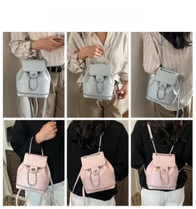 Detail view of stylish small backpack in light blue and pink with chain straps