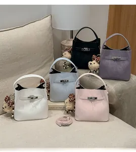 Close-up of leather bucket bags in five colors with cute bear charms and metal locks
