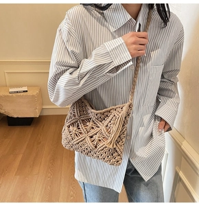 Detail view of beige woven crossbody bag with hollow diamond pattern and long tassels