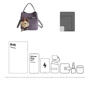 Detail showing purple bucket bag capacity with a cute bear charm and storage icons