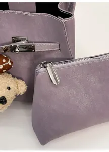 Detail view of purple lychee grain bucket bag with a removable zip inner pouch