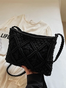 Handmade black woven crossbody bag with fringe tassels for casual beach vacations