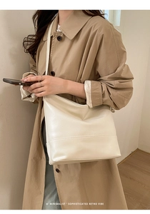 Minimalist beige retro hobo bag shown in high-quality leather texture on a model
