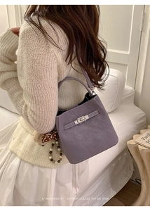 Detailed macro view of lavender bucket bag with silver metal twist lock and bead charm