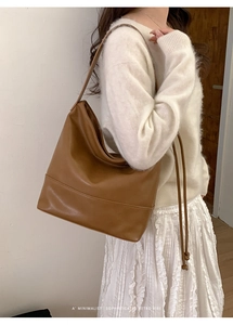 Retro brown leather large shoulder bag shown on model with minimalist sophisticated vibes
