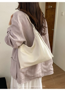 Minimalist beige PU leather hobo shoulder bag shown on model for a retro sophisticated look