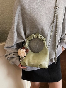 Chic light green dumpling crossbody bag with ruffled handle and bear keychain charm