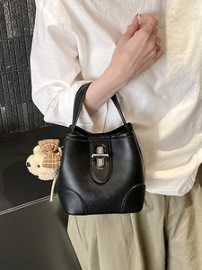 Minimalist black bucket handbag with silver lock and a cute bear pendant for women