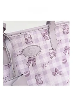 Close-up of purple plaid tote bag with cute cat prints and textured leather finish