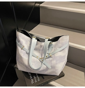 Detail shot of large canvas tote bag with abstract blue texture and leather straps