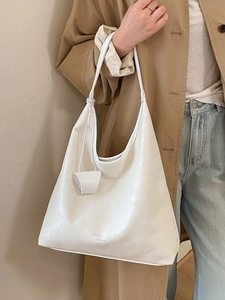 Minimalist white faux leather large tote bag with brand lettering for casual shoulder wear