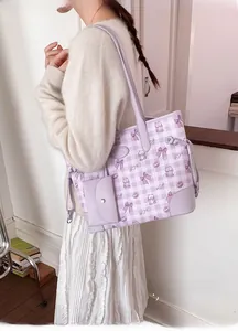 Detail of lavender plaid tote bag featuring teddy bear prints and mini coin purse charm