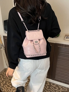Chic pink leather bucket backpack with gold chain straps and metal twist lock for women