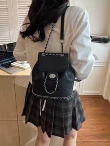Fashionable black chain backpack for women with metal twist lock and bucket silhouette