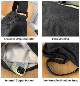 Detail view of black nylon crossbody bag showing reinforced stitching and inner zip pocket