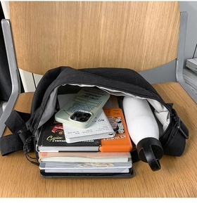 Detailed internal view of large black nylon crossbody bag with spacious storage capacity