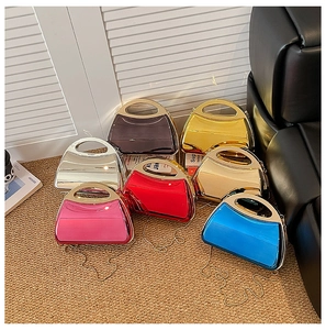 Showcase of glossy acrylic evening clutch bags in seven vibrant metallic colors with chain straps