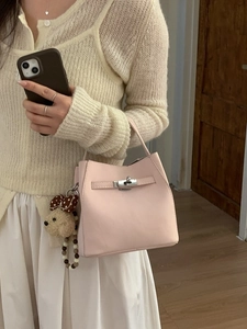 Chic light pink trapezoid handbag with silver turn-lock and cute teddy bear charm