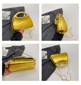Detailed views of gold acrylic box bag featuring polished mirror finish and chain strap