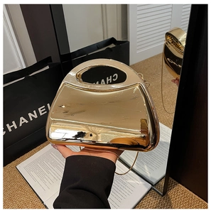 Detailed view of the gold mirror finish acrylic evening bag with a metal chain strap