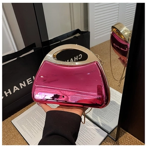Pink metallic acrylic evening bag with gold circular handle and glossy mirror finish