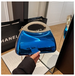 Detail of blue mirror acrylic clutch bag with round gold handle and metal chain strap