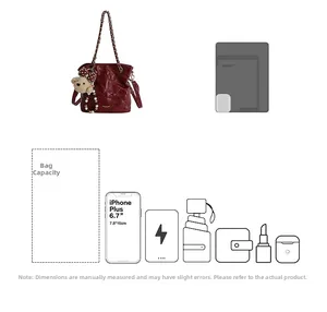 Detail showing burgundy quilted bucket bag capacity for phone, umbrella, and wallet