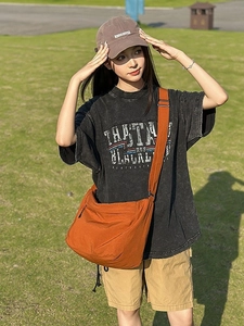 Orange-brown nylon crossbody bag with wide strap and large capacity for daily casual use