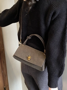 Elegant dark grey structured flap handbag with gold turn-lock and knotted handle detail