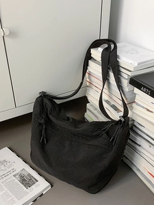 Large black nylon crossbody dumpling bag with wide adjustable strap for daily sports and school