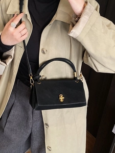 Elegant black leather square handbag with gold twist lock and a long shoulder strap