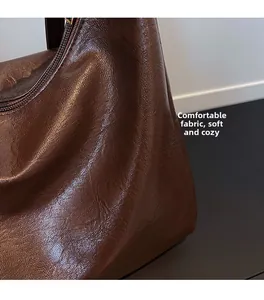 Detail of soft dark brown leather tote bag showing rich lychee grain and oil wax finish