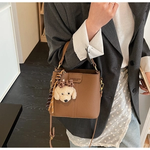 Brown litchi texture bucket bag with a stylish silk scarf and cute puppy charm detail