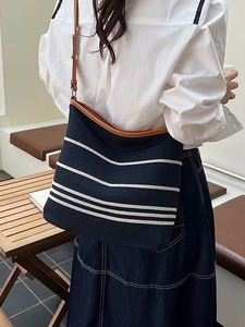Classic black and white striped canvas bucket bag with brown leather straps for women