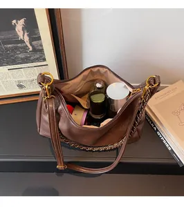 Detailed view of the vintage brown tote bag showing large capacity and internal pockets