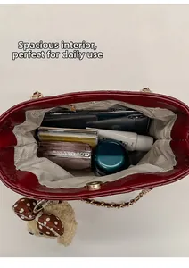 Detail view of red bucket bag interior showing spacious storage and magnetic closure
