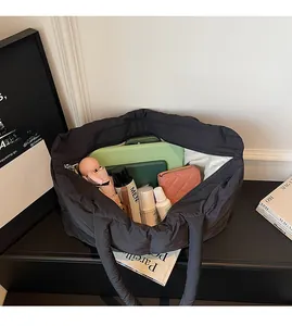 Interior view showing the large capacity of this black quilted puffy tote bag