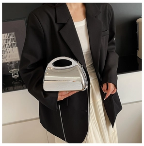 Detail view of the silver mirror acrylic box bag with metal chain and circular handle