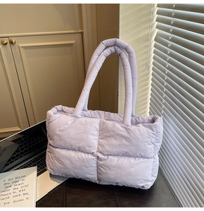 Quilted light purple tote bag with a padded texture shown in an aesthetic office setting