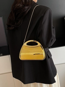 Glossy gold acrylic box clutch with mirror finish and slim metal chain shoulder strap