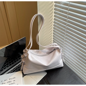 Detail view of a light purple shoulder bag with glossy texture and knotted strap design