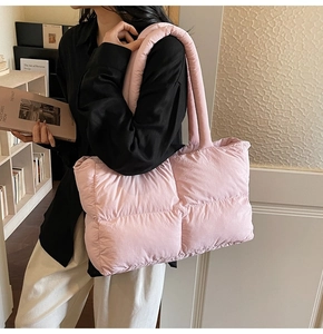Close-up of pink quilted puffer tote bag with soft padded handles for women