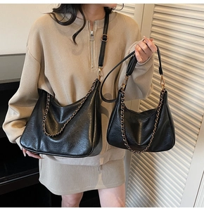 Comparison of large and small black hobo bags with bronze chains and leather straps