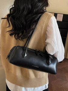 Classic black leather dachshund baguette shoulder bag with gold logo and dual straps