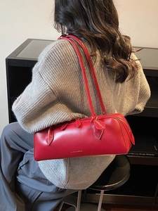 Elegant red cylindrical shoulder bag in minimalist French style with dual thin straps