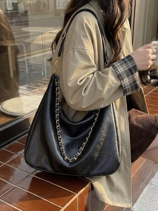 Vintage black leather hobo tote bag with gold chain strap for stylish urban commuting