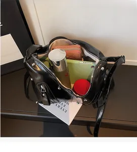 Detailed interior of black leather tote bag showing large capacity for phone and wallet