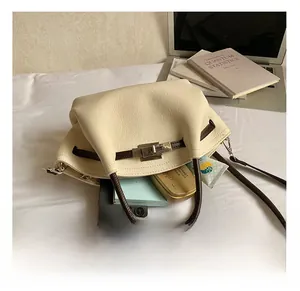 Spacious interior of beige pebbled leather bucket bag showing daily essentials